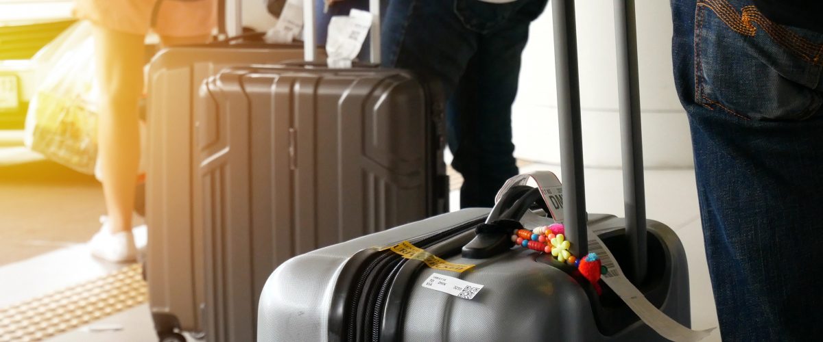 airport taxi. passenger with big roller luggage standing on the line waiting for taxi queue at taxi parking lot at airport arrival terminal airport taxi. passenger with big roller luggage standing on the line waiting for taxi queue at taxi parking lot at airport arrival terminal